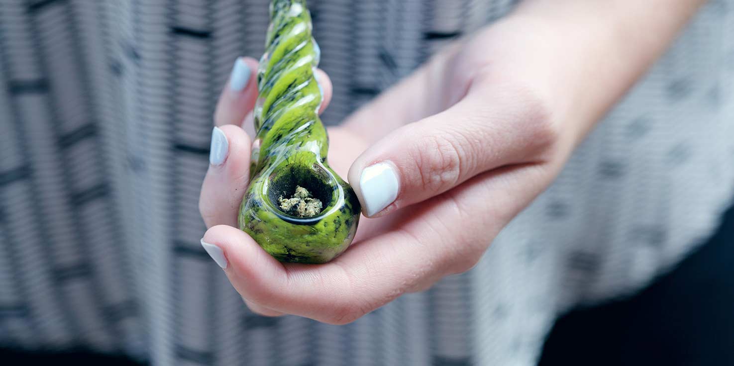 person holding a small pipe