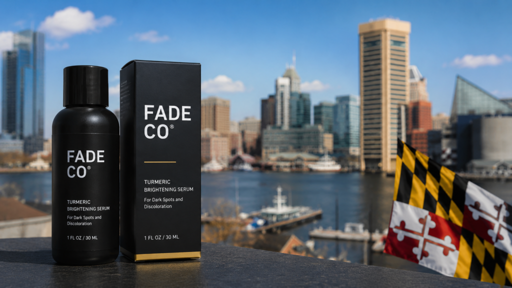 **Alt Text:** Fade Co cannabis product packaging displayed in the foreground with the Baltimore Inner Harbor skyline and Maryland state flag in the background under a clear blue sky.